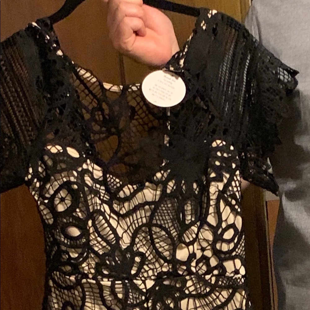 Black and cream lace dress with key hole opening.